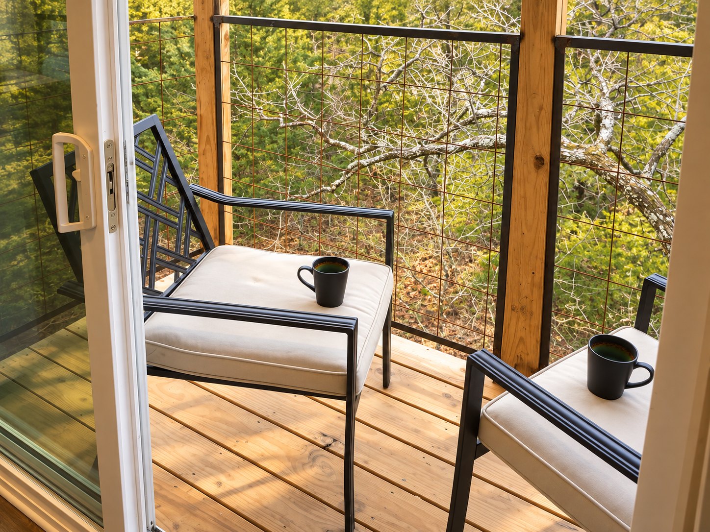Two chairs and two coffee mugs on the treetop balcony