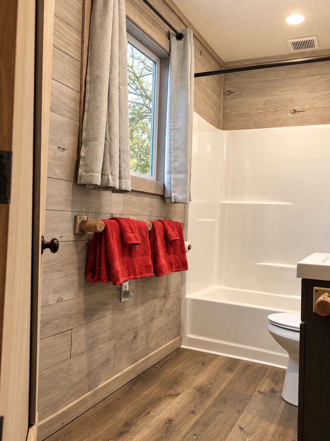 Full bathroom with red towels